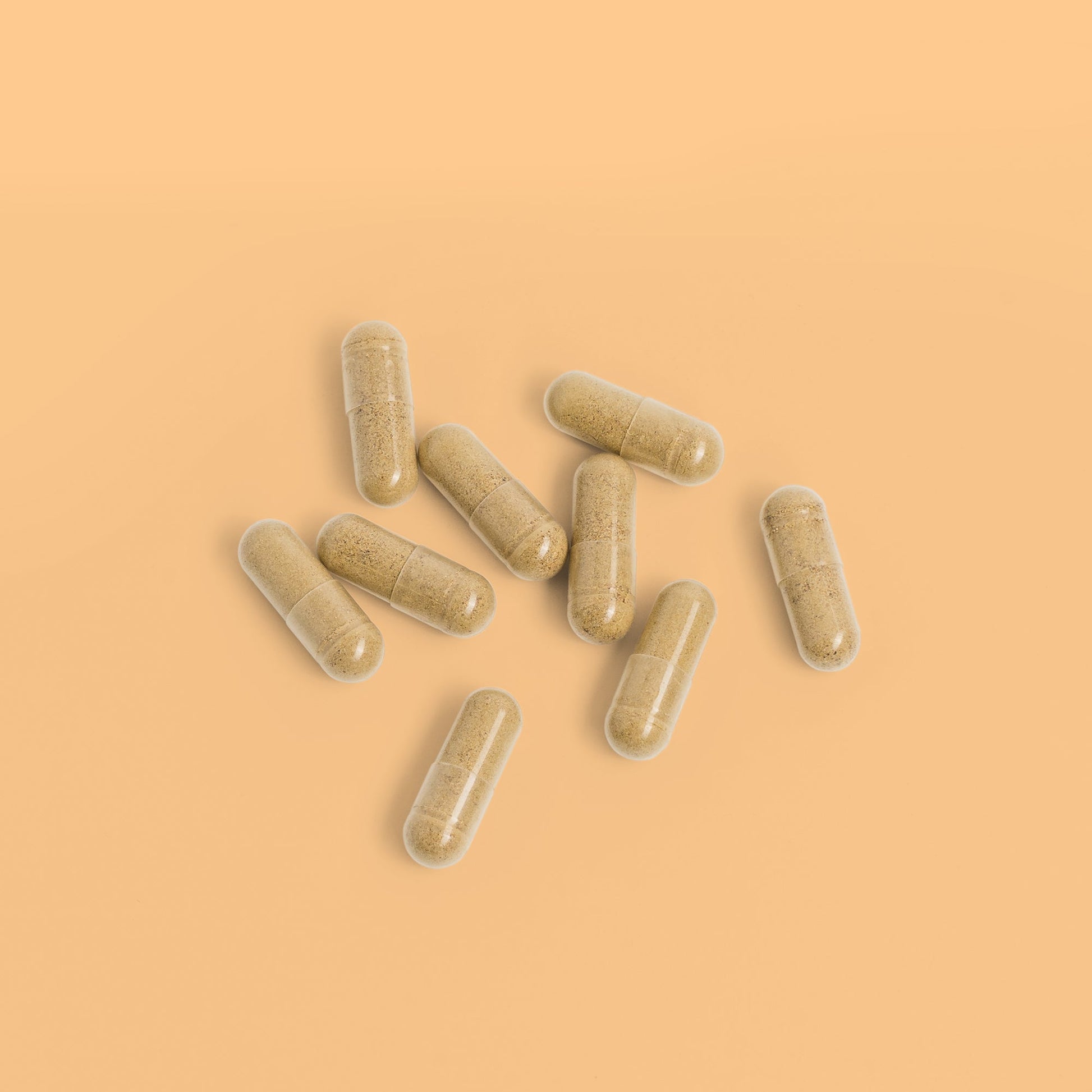 Close-up of Herbaly's Derma Hair, Skin & Nails + Biotin Capsules showing their size, shape, and color